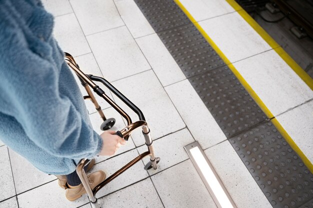 Hands holding walking frame high angle