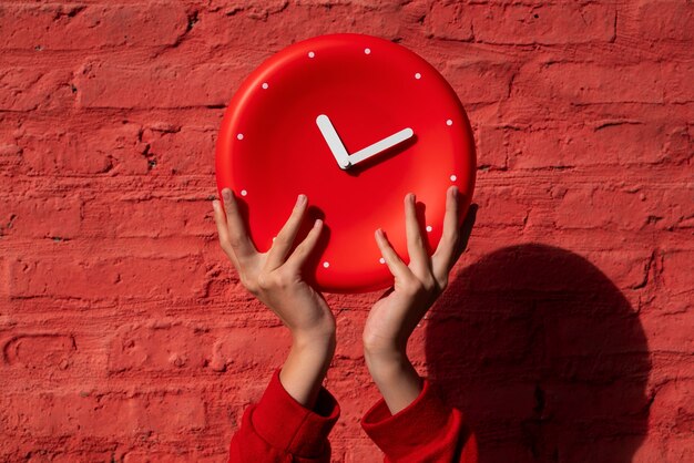 Hands holding wall clock still life