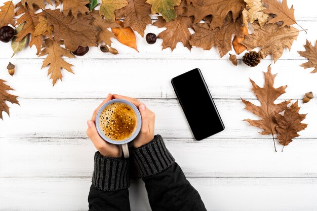 Hands holding warm coffee cup