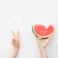 Free photo hands holding a watermelon