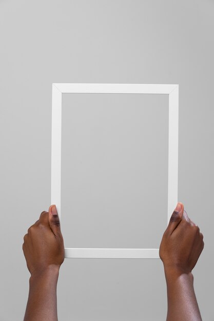 Hands holding white frame front view