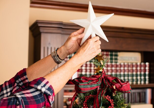 Hands holding a white star