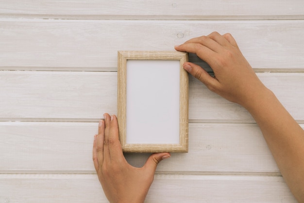 Hands holding a wooden frame