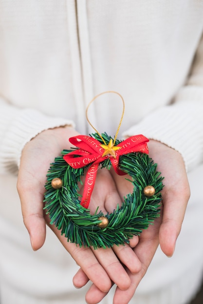 Free photo hands holding wreath