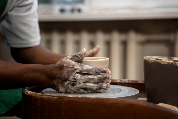 Hands making bowl side view