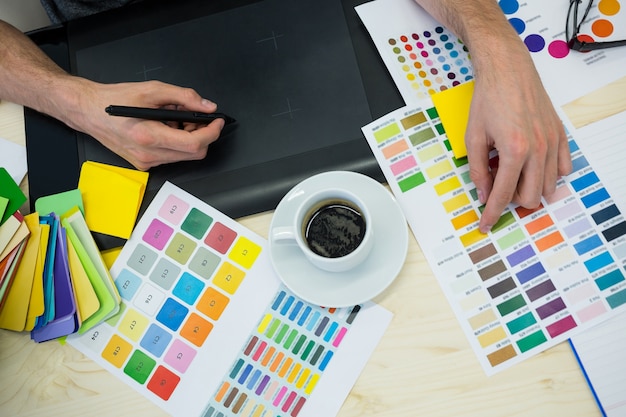 Hands of male graphic designer using graphics tablet