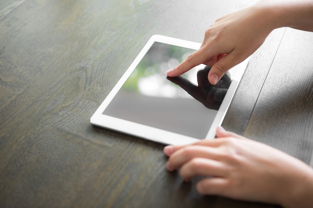 Hands manipulating a tablet