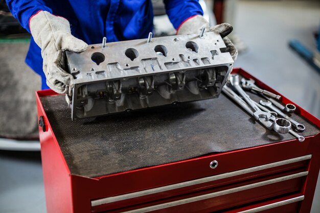 Hands of mechanic checking car parts