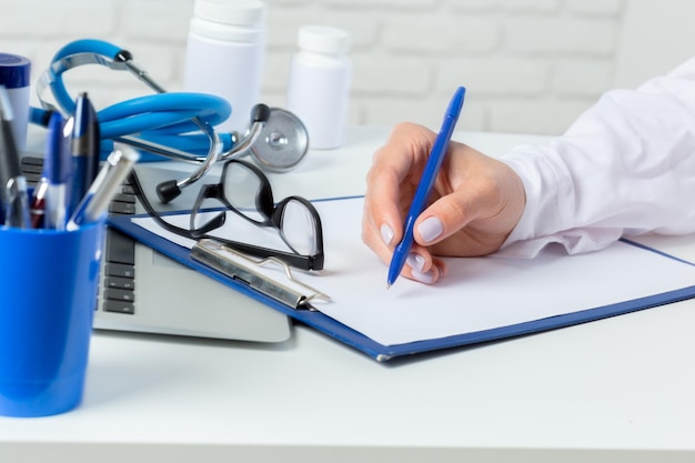 Hands of medical doctor woman with laptop