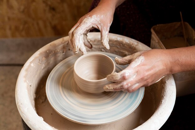Hands modeling in clay on a potter's wheel