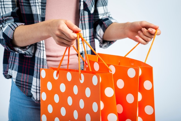 Hands opening polka dot shopping bags