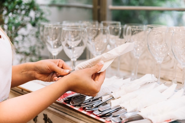 Hands organizing cutlery