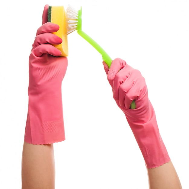 Hands in a pink gloves holding sponge and brush 
