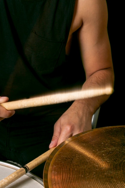 Hands playing drums with sticks