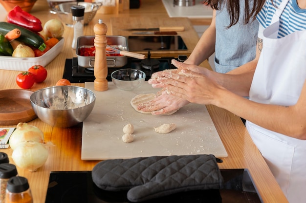 Hands preparing dough close up