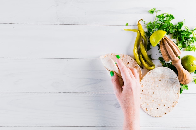 Hands preparing tasty mexican food