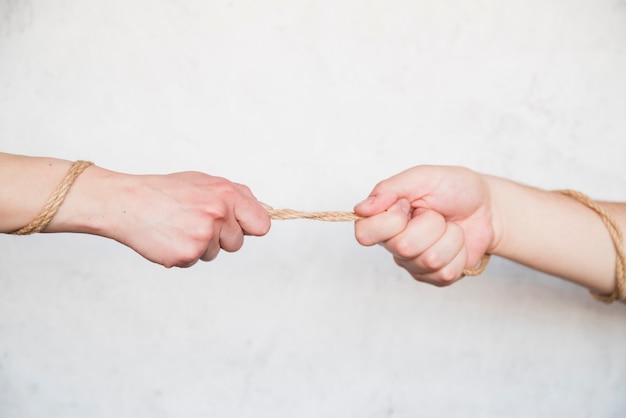 Hands pulling rope