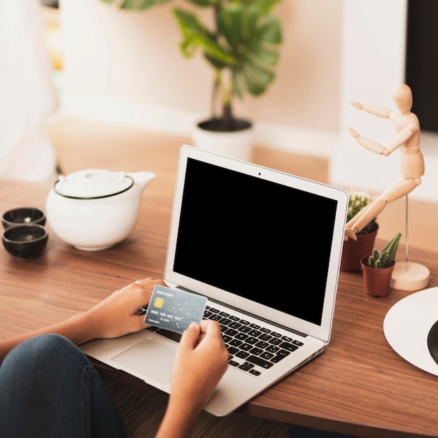 Hands putting a card on a laptop mock up