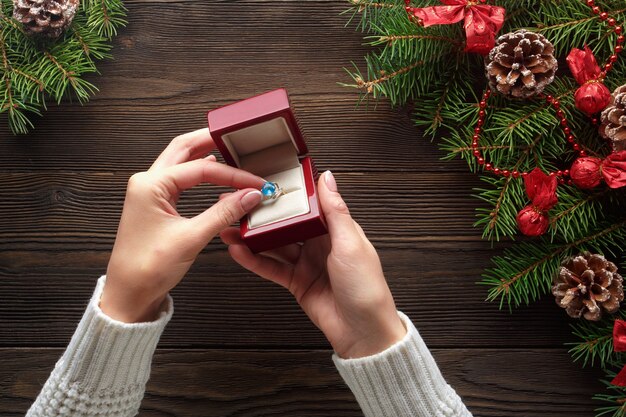 Hands putting a ring in a red box