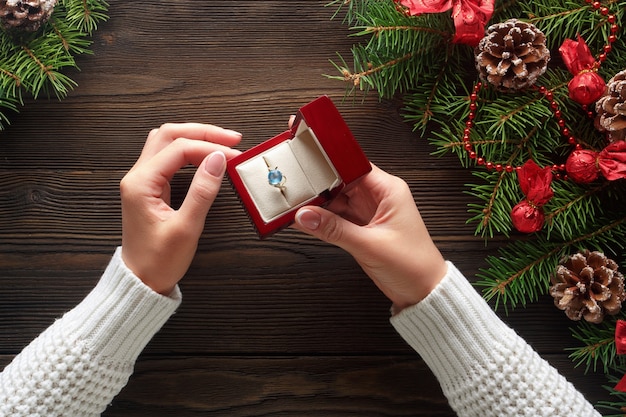 Free photo hands putting a ring in a red box