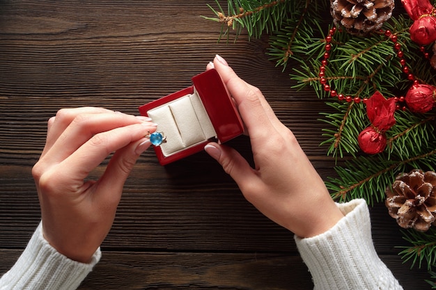 Hands putting a ring in a red box