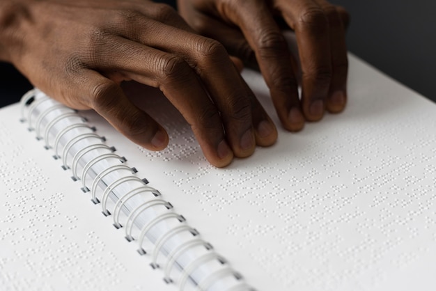 Hands reading braille close up