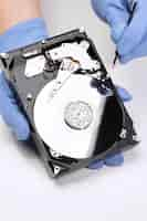 Free photo hands repairing hard drive high angle