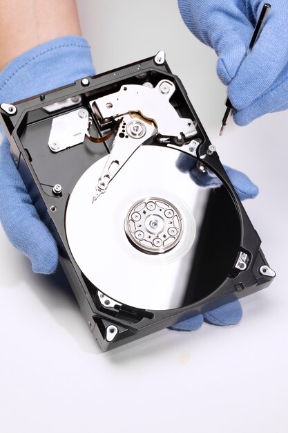 Hands repairing hard drive high angle