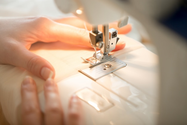 Hands at sewing machine