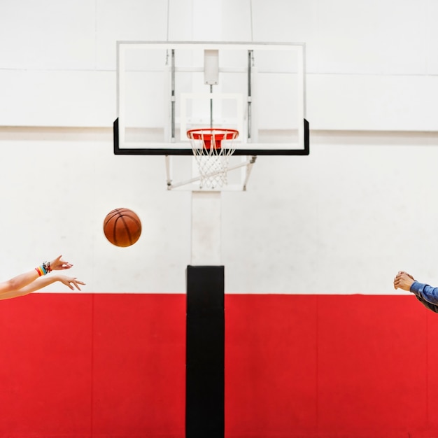 Free photo hands shooting basketball to the net hoop