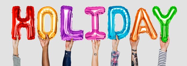 Hands showing holiday balloons word