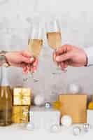 Free photo hands toasting champagne glasses