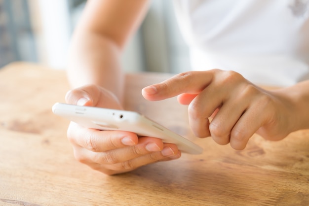 Hands touching a smartphone