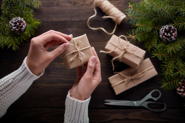 Hands tying the knot of string of gift packages