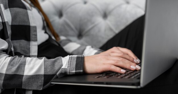 Hands typing on laptop close up