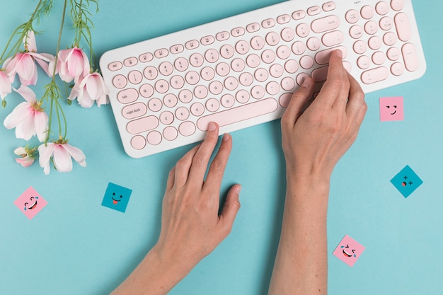 Free photo hands typing on pink keyboard