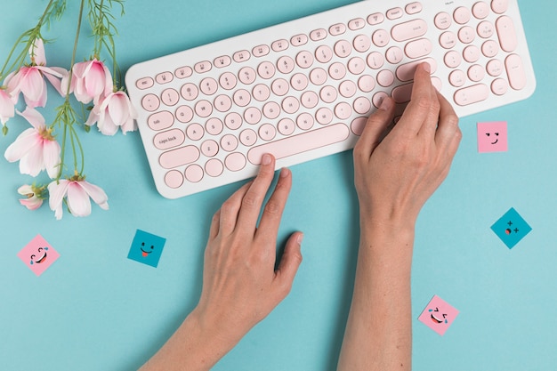 Hands typing on pink keyboard