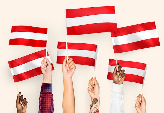 Hands waving flags of austria