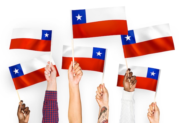 Hands waving flags of Chile