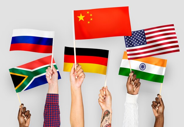 Hands waving flags of China, Germany, India, South Africa, and Russia