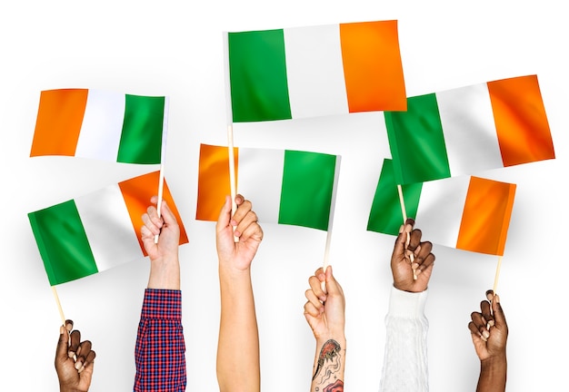 Free photo hands waving flags of ireland