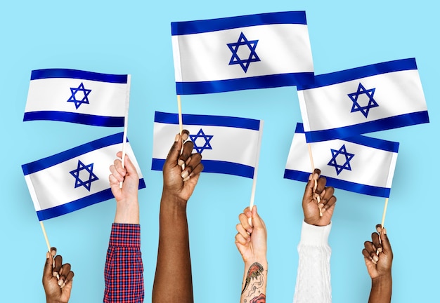 Free photo hands waving flags of israel