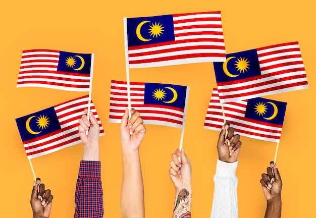 Hands waving flags of Malaysia