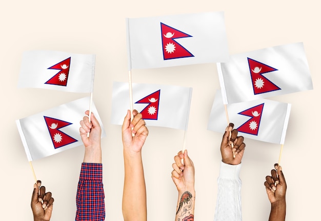 Free photo hands waving flags of nepal