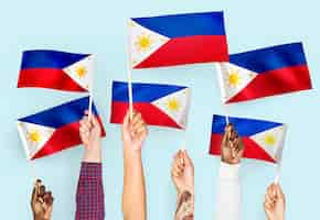 Free photo hands waving flags of the philippines