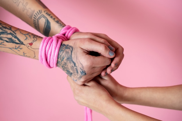 Hands wearing pink rope high angle