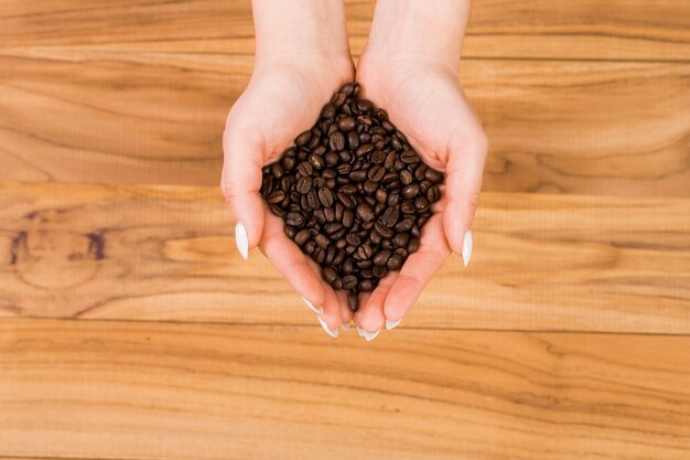 Hands with coffee beans