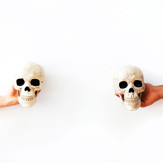 Hands with fake skulls