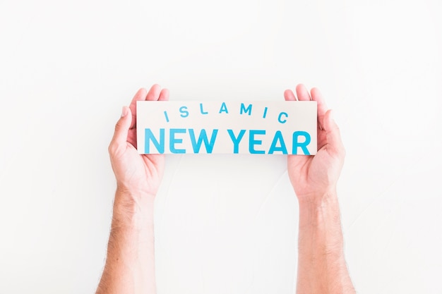 Hands with Islamic New Year paper 