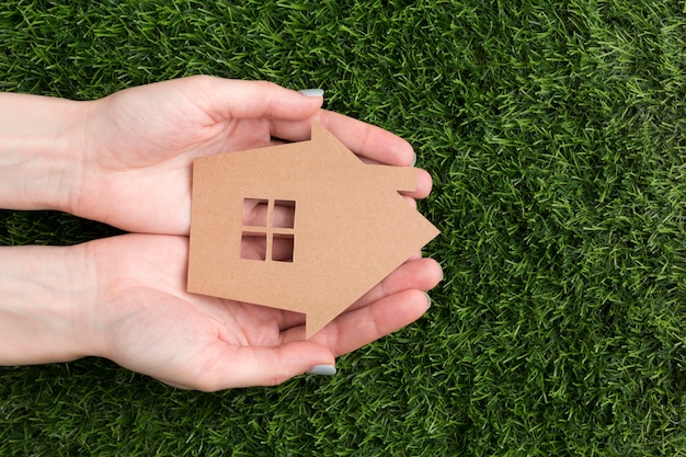 Hands with miniature house